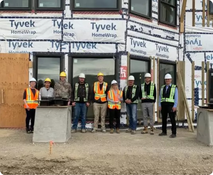 NRB team members in front of a building site