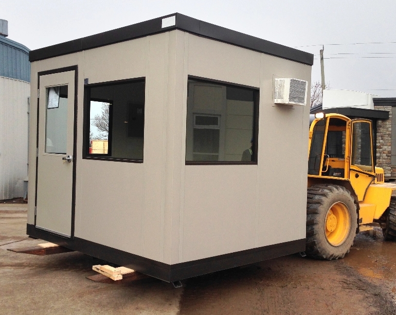A small modular building being moved by a fork lift