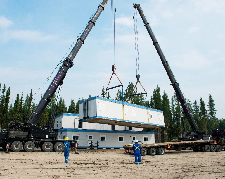 Cranes lowing a modular unit