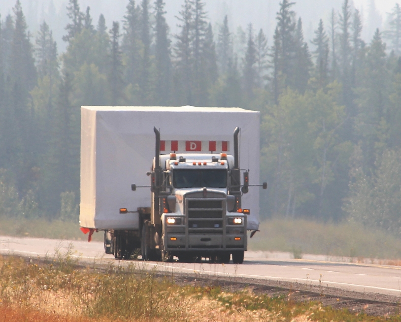 A relocatable structure being transported on a truck